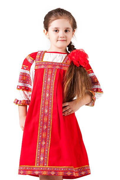 girl in embroided colorful traditional slovakian costume during Easter holiday with basket full of eggs in village