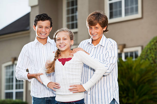 Family standing outside house