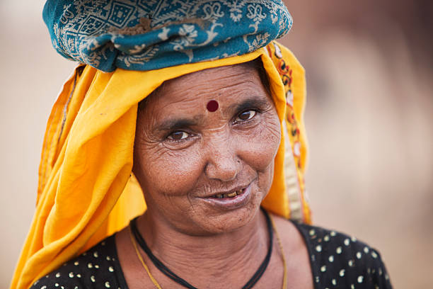 istock Mature Indian Woman with cast mark smiling at camera 184649848