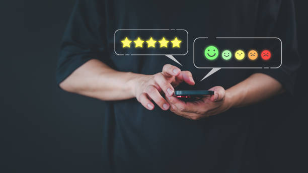 istock Customer use a smartphone give point 5 stars and smile face icon for feedback review satisfaction service opinion and testimonial on application. Online customer review satisfaction feedback survey. 1846501947