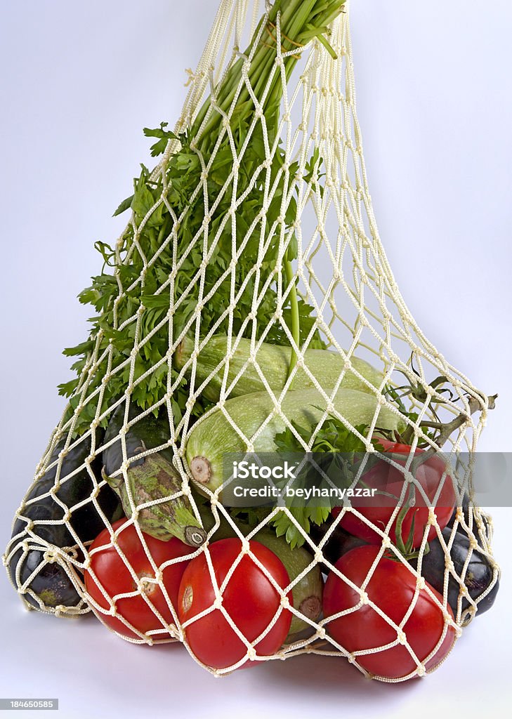 String bag and vegetable Vintage string shopping bag with veg from low perspective.MORE >>> Bag Stock Photo