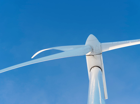 Renewable wind power generation. Wind turbine against the blue sky.