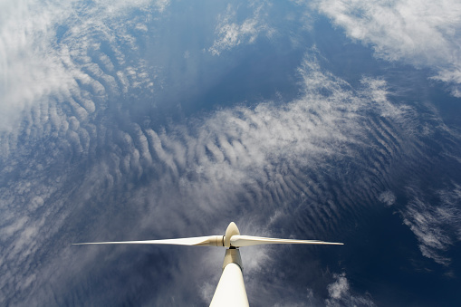 Renewable wind power generation. Wind turbine against the deep blue sky.