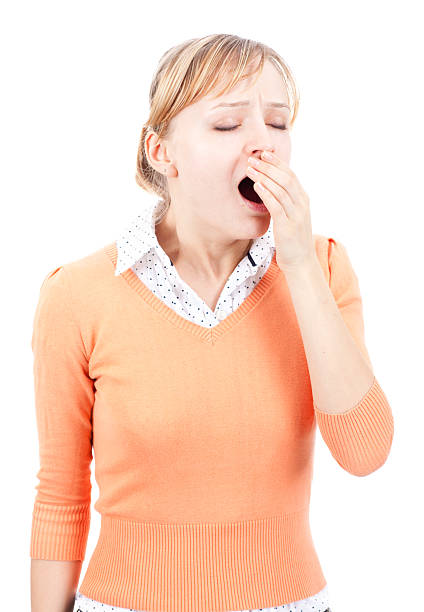 istock Young woman yawning isolated on white 184650946