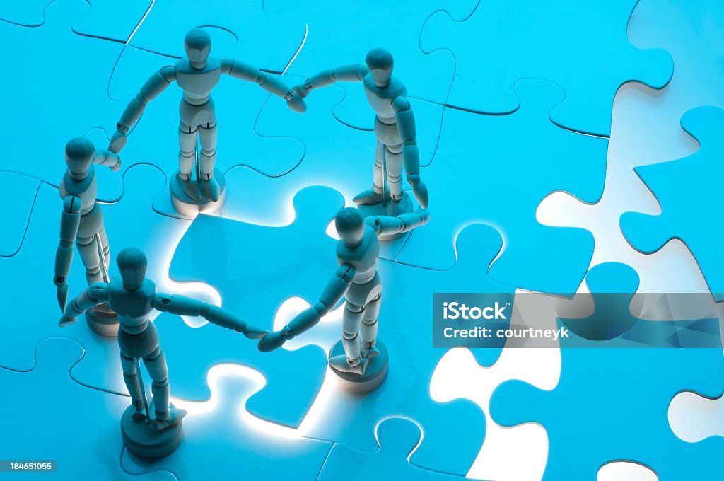 Social network solutions concept with wooden figures Social network concept with wooden figures finishing a jigsaw puzzle A Helping Hand Stock Photo