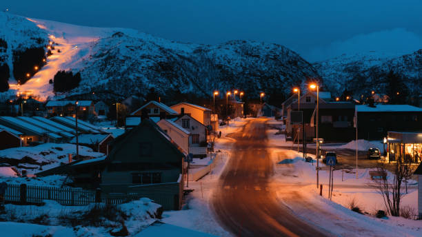 istock Small village with snowy mountains during evening time 1846512635