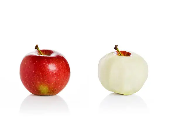 Photo of Apples on white background, peeled and unpeeled