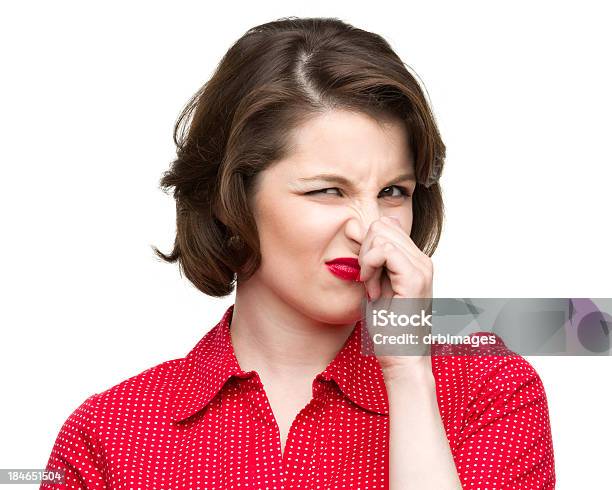 Woman In Red Pinching Her Nose Showing Dislike Stock Photo - Download Image Now - Holding Nose, One Woman Only, Only Women