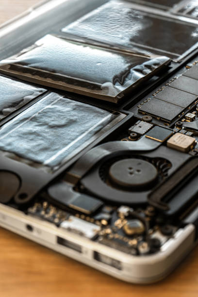 istock Swollen battery of broken laptop in open casing closeup 1846516971