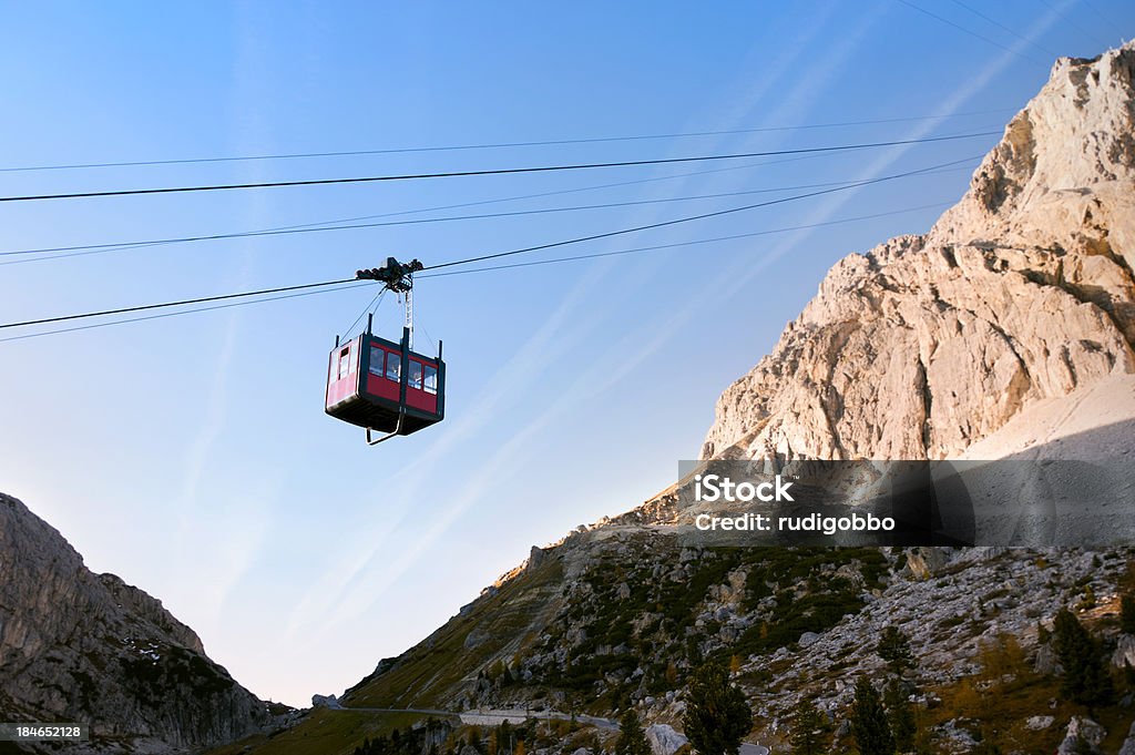 Overhead cable car in Italy "In the Italian dolomites, an empty overhead cable car going up to Lagazuoi at sunset. Focus on the cabin." Dolomites Stock Photo