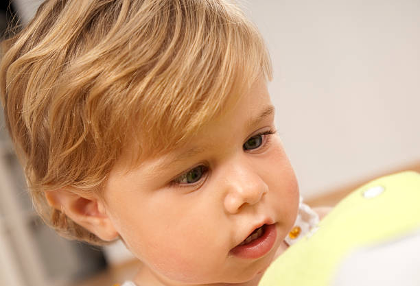 Little cute girl with blonde hair  laughing, indoor, close up portrait