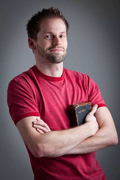 Happy man holding his old used bible