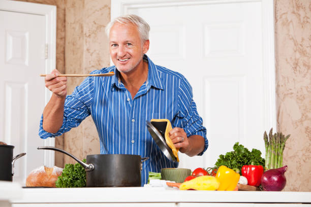 istock Man tasting food from pot on stove 184652826