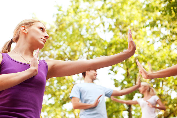 istock Group of Young People Practicing Tai Chi Outdoor 184653064