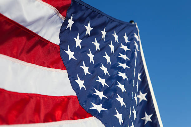 istock American flag against blue sky 184653336
