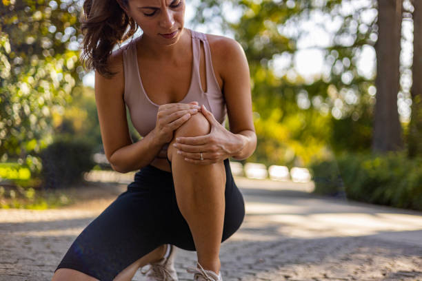 istock Young woman feeling pain in her knee. 1846535409