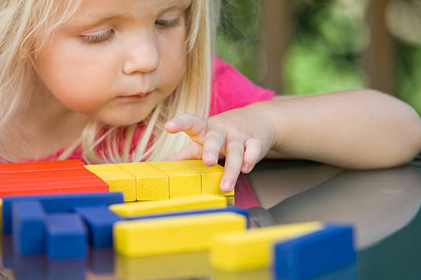 istock Three Year Old Girl Plays with Blocks 184653641