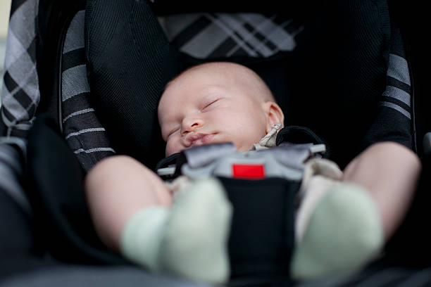 Two month old baby car seat sleeping stock photo