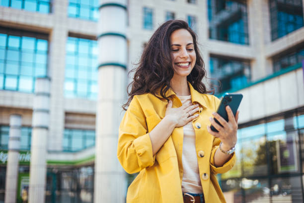 istock Woman using smartphone and drinking coffee at the city. 1846539361