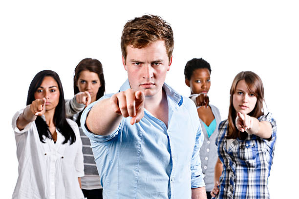 istock Five angry young adults point at the camera accusingly 184654167