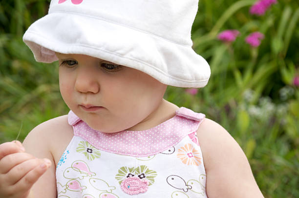 istock One year old examining blade of grass. 184654274