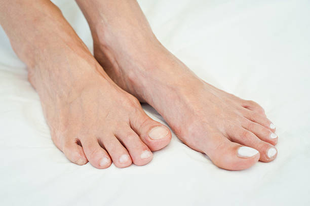 istock Female Feet With White Nail Polish 184655030