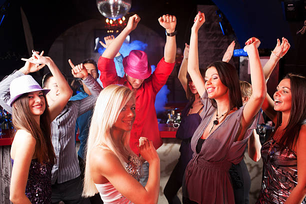 istock Group of young people dancing at the discotheque. 184655089