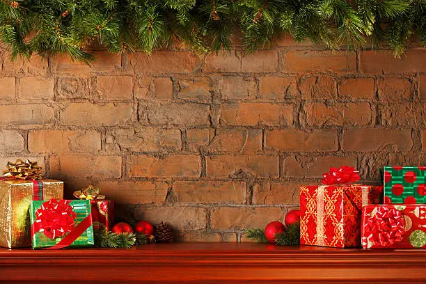 Christmas presents on a mantelpiece with a Christmas garland above.To see more holiday images click on the link below: