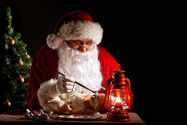 istock Santa Claus painting a toy 184655362