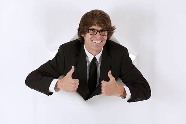 istock Businessman emerging from a hole of paper 184655618