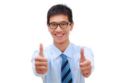 studio shoot of young asian businessman looking at camera smile with thumb up.