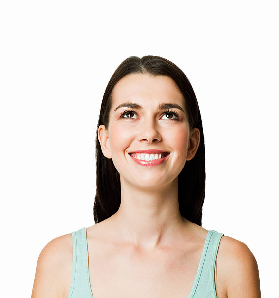 istock Young Woman Looking Upwards - Isolated 184655696
