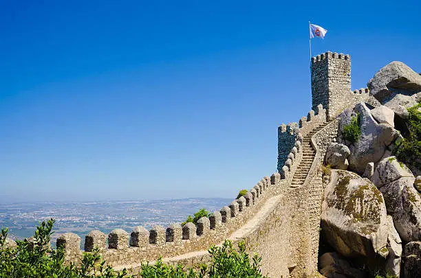 "Castle of the Moors, also known as Castelo dos Mouros, in Sintra, Portugal with a flag bearing the Portuguese Shield. Other images of Sintra:"