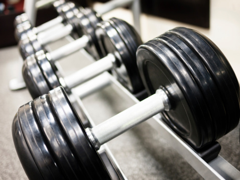 Healthclub gym dumbbell weights on a rack