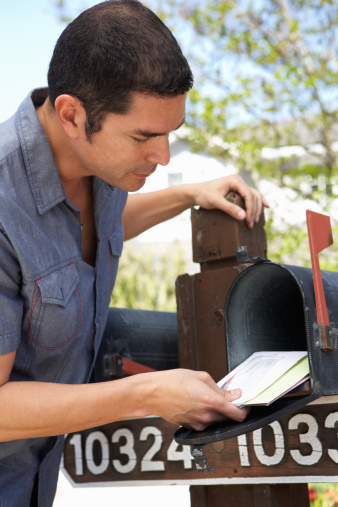 Hispanic Man Checking Mailbox For Post