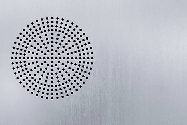 Speaker grille on stainless steel surface, part of an information panal.