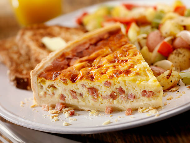 Ham and Cheese Quiche with Orange Juice "Ham and Cheese Quiche with Pan Roasted Hashbrown Potatoes, Peppers and Onions with Whole Wheat Toast and a Glass of Orange Juice- Photographed on Hasselblad H3D2-39mb Camera" quiche stock pictures, royalty-free photos & images