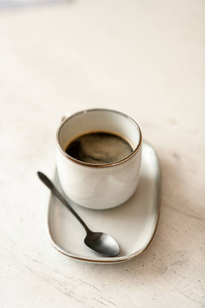 istock Hot strong espresso served in small white cup with saucer and teaspoon 1846576980