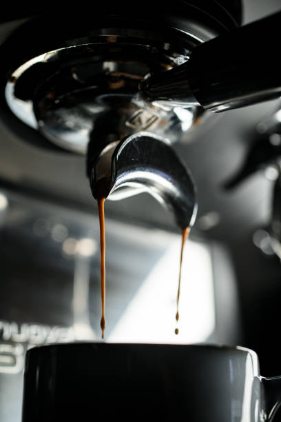 istock Close up view on professional coffee machine with modern bottomless filter prepares espresso beverage 1846577095