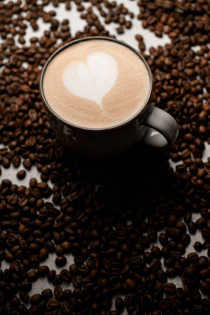 istock Tasty hot fragrant latte in white cup with beautiful heart pattern on foam 1846577347