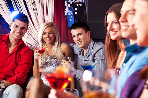 istock Young people holding drinks at the bar 184658026