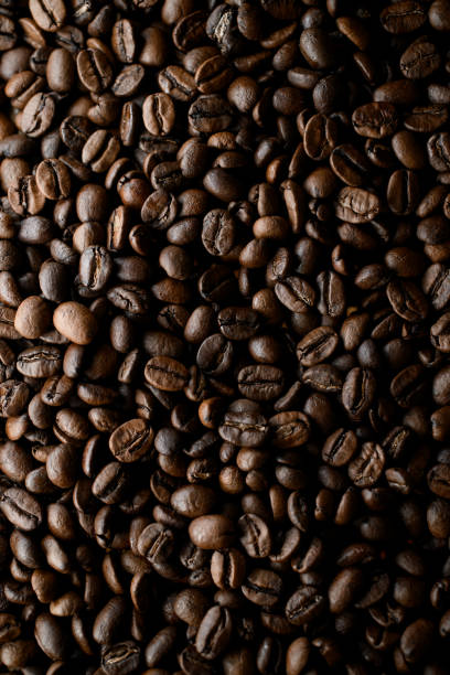 istock Vertical view of dark brown fresh roasted coffee beans background. Copy space 1846580446