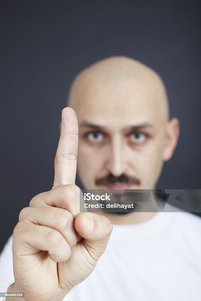 One rule "Man showing index finger. Focus on finger, shallow depth of field." Achievement Stock Photo