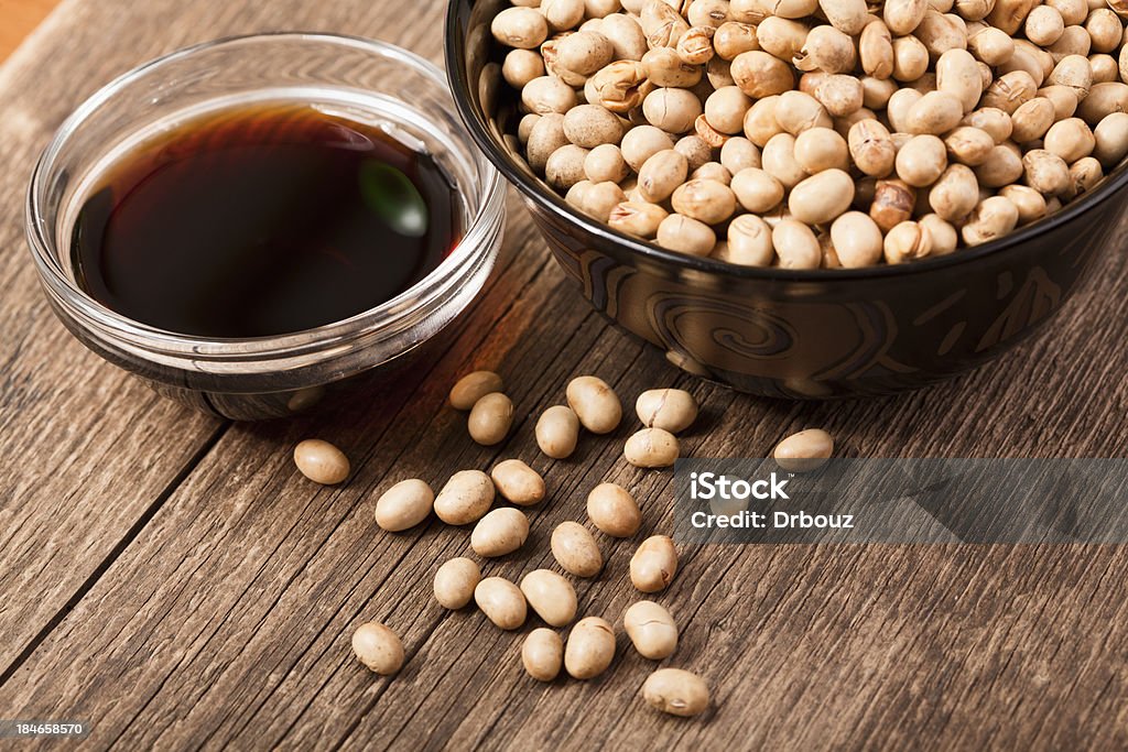 Soy products Dry-baked soy grains in the cup with soy sauce nearby; closeup; Adobe RGB color spacesee other similar images: Soy Sauce Stock Photo