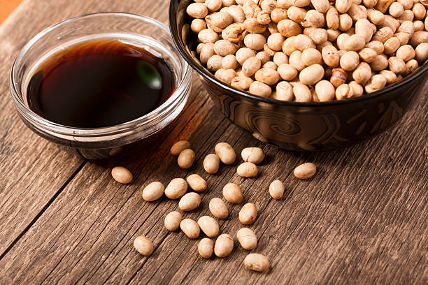 Soy products Dry-baked soy grains in the cup with soy sauce nearby; closeup; Adobe RGB color spacesee other similar images: soy sauce photos stock pictures, royalty-free photos & images