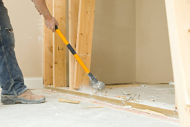 Construction Worker Using a Sledgehammer to Remove Wall Stud stock photo