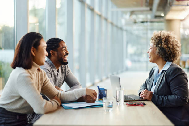istock Happy diverse couple talking to their agent in the office. 1846591822