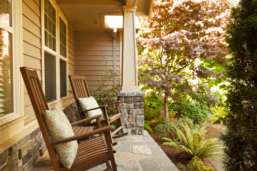 Two rocking chairs on a beautiful front porch.