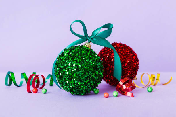 istock Christmas ball on colored background. decoration bauble with ribbon bow with copy space 1846593431