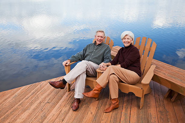 istock Senior couple sitting by water 184659497